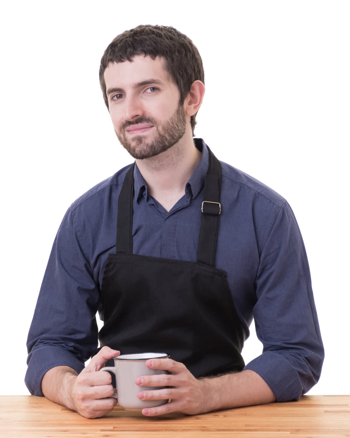 Fede wearing a black apron, holding a mug